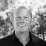 mark A black and white photo of a bald, white man. Age around 60